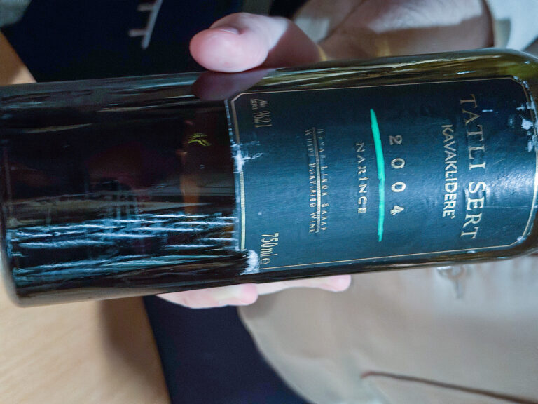 A bottle of Tatli Sert from 2004 held up to the light