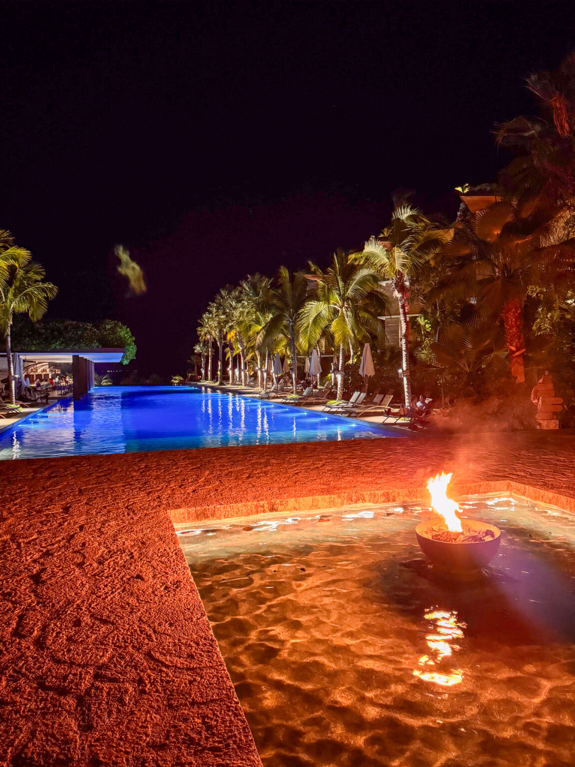 The pool washed red and orange by firelight