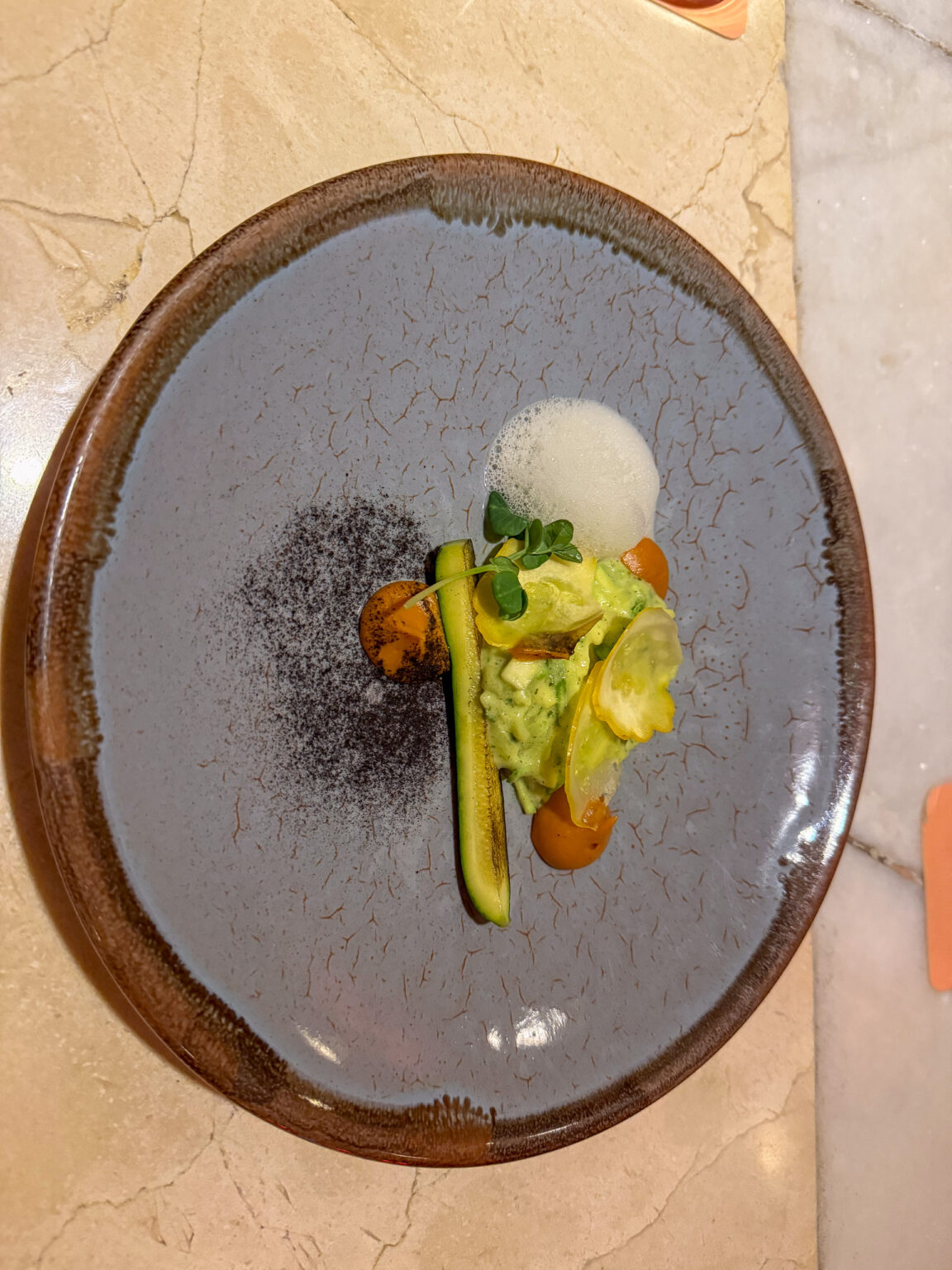 A plated dish seen from above on a dark stone plate