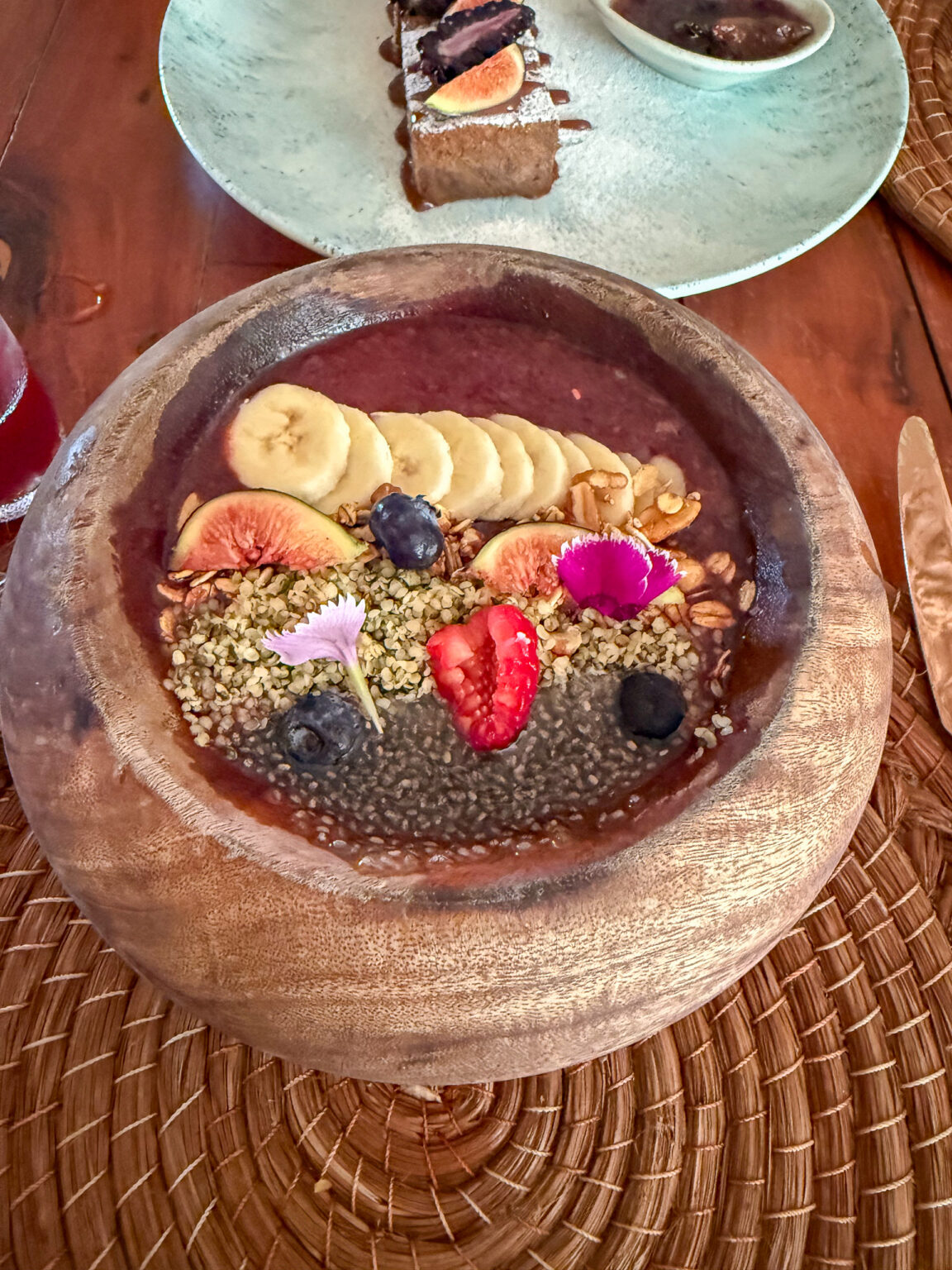 Chocolates and fruit arranged on a woven charger