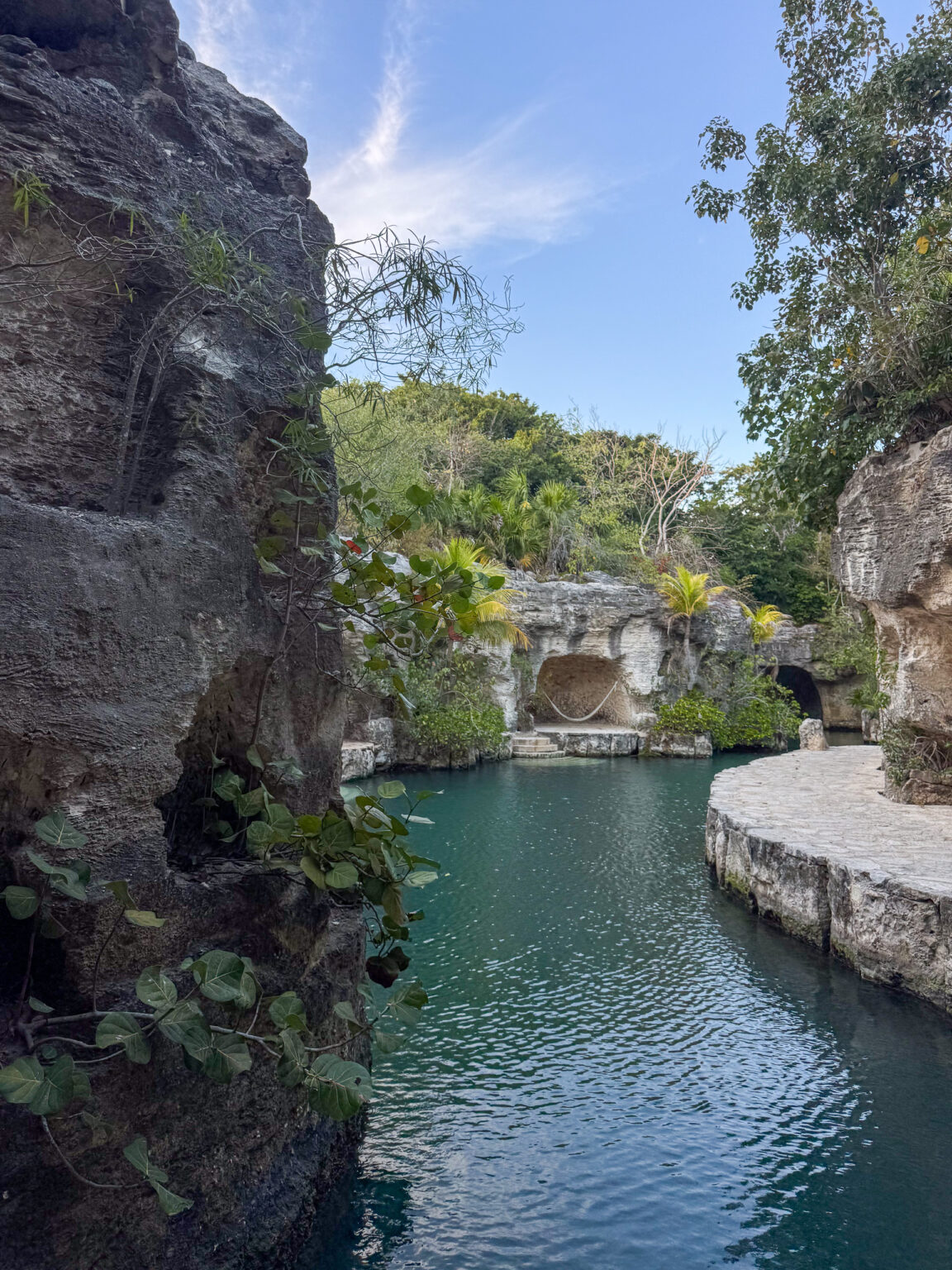 A narrow channel of green water between high rock walls