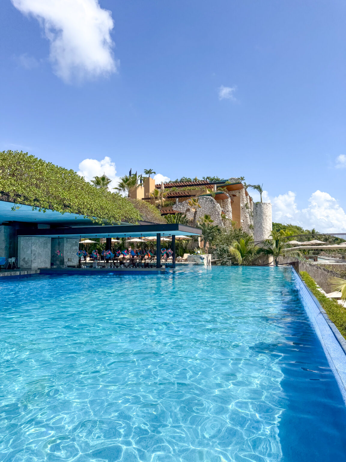 The pool beside the restaurant terrace, jungle behind